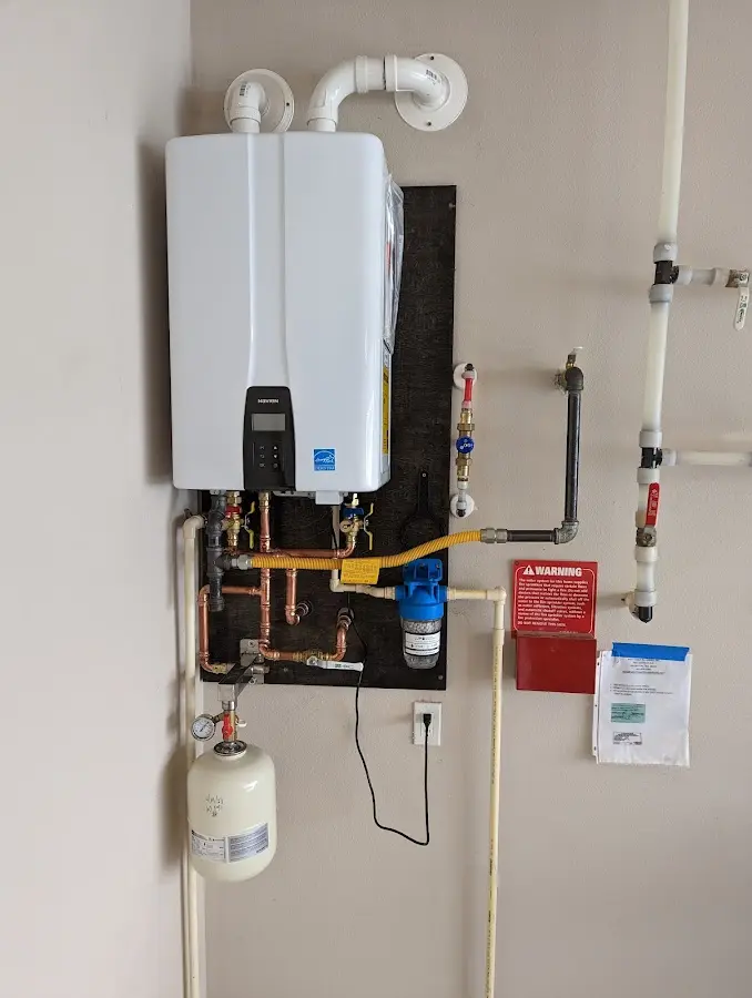 Professional plumber installing copper piping in a Rowlett home